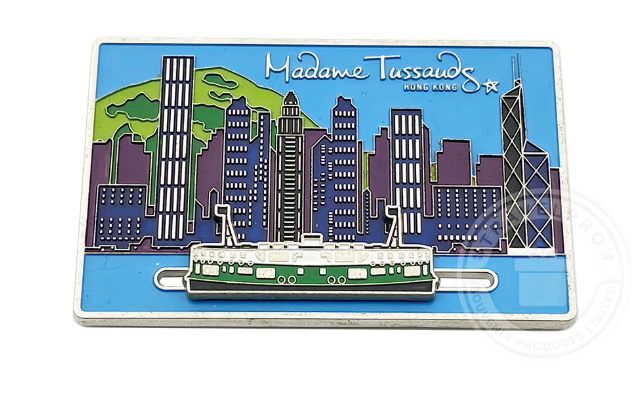 Assorted souvenir decorative items including keychains, magnets, coins, and ornaments, showcasing elegant craftsmanship and perfect as travel keepsakes or personalized gifts.